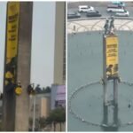 Greenpeace Activists Scale Welcome Monument in Jakarta, Unfurl Banners Demanding Climate Action and Lower Living Costs